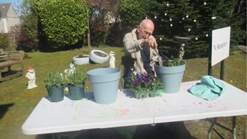 Gardening and soaking up the sunshine for Llansamlet Resident